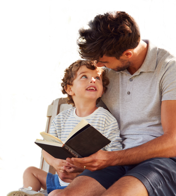 child and man reading a book
