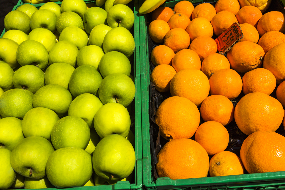 Granny smith apples and oranges in the crates for sale at a market stall, Rome, Rome Province, Lazio, Italy